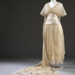 Wedding dress of silk satin with a tulle train, designed by Aida Woolf, London, 1914 © Victoria and Albert Museum, London
